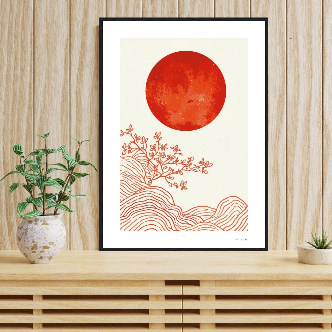 Pintura abstracta minimalista, estilo Japandi, enmarcado en madera negro con un gran círculo o sol de color terracota o marrón rojizo en el centro, y trazos sutiles en blanco y beige en estantería tamaño 50x70 cm